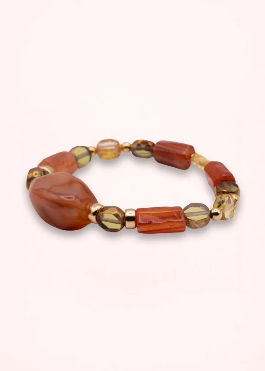 Bracelet Sienna élastique en cornaline naturelle, perles de verre de Bohême aux tons orangés et détails dorés en or laminé 14K, sur fond clair.