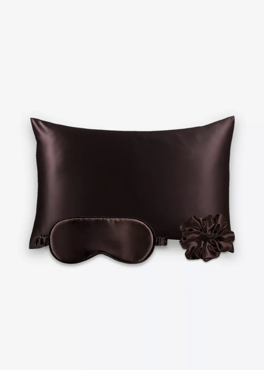 Coffret Les Essentiels : taie d’oreiller, masque de nuit classique et grand chouchou, tous en soie marron chocolat.